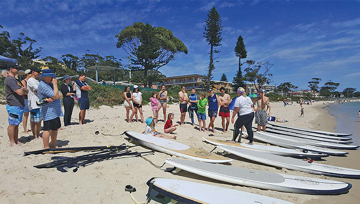 A beautiful day as the community learn how to Stand Up Paddleboard Photo: Shoal Bay SUP