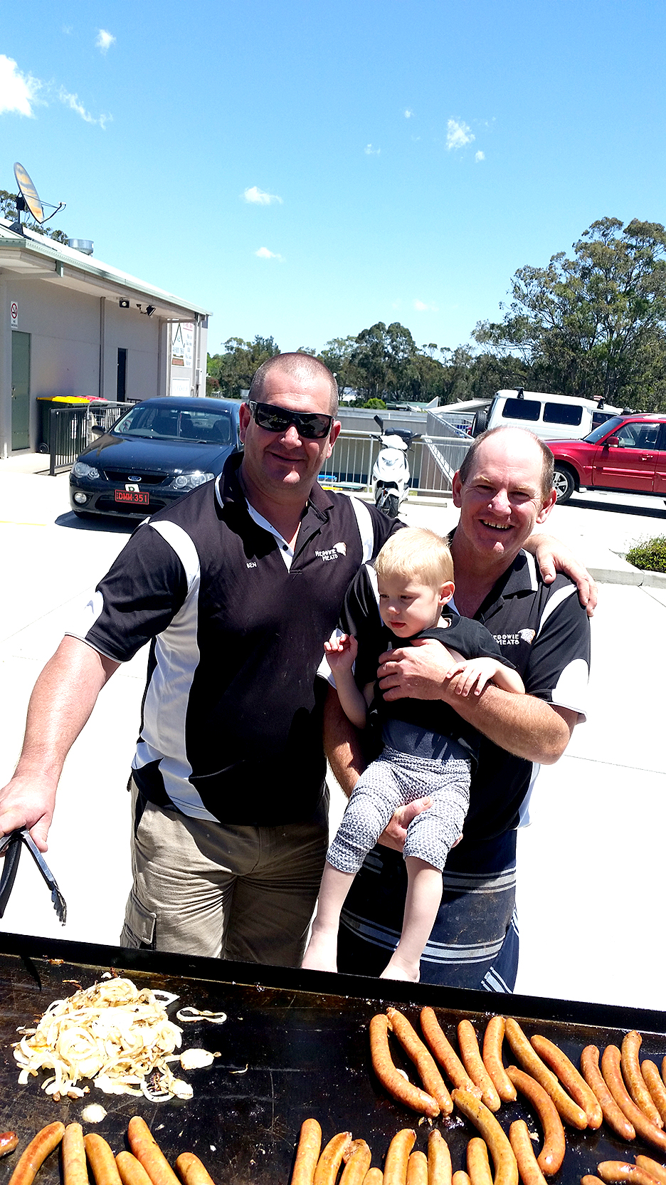 Ben and Shaun from Medowie Meats, with young Carter Goodwin.