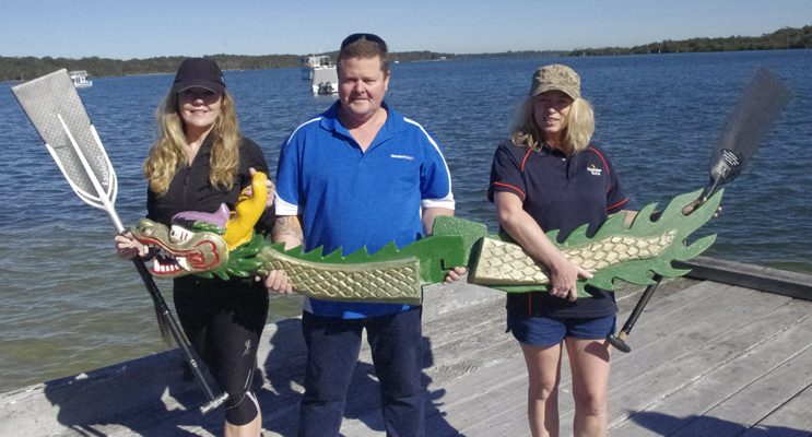 Deb and Andrew Downey, with Cherie Livingstone at Taylors Beach with the donated Dragon Boat Head and Tail. Photo by Marian Sampson.