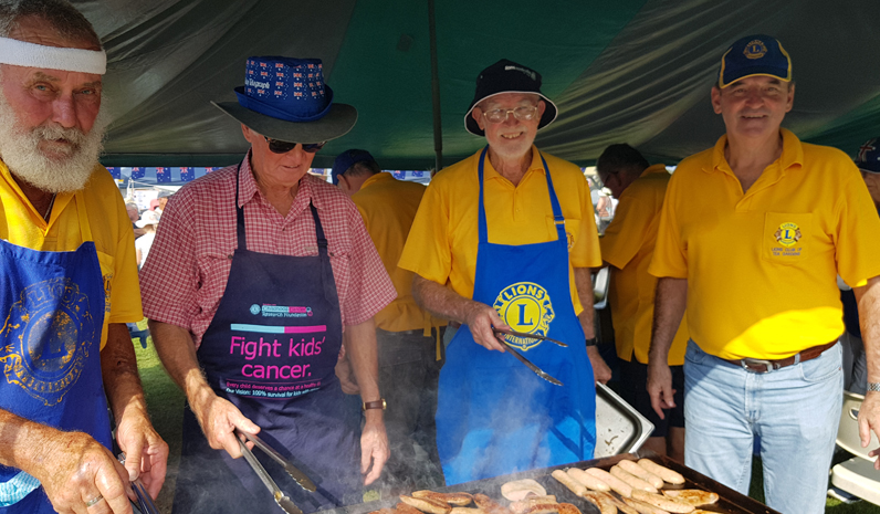 HOT WORK: Lions sizzling the sausages on Australia Day.